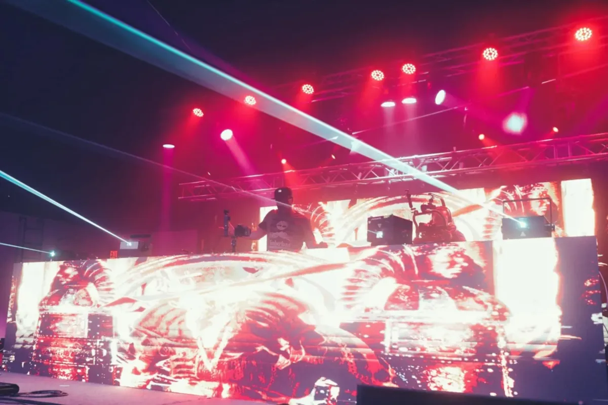 DJ performing at a live concert with laser beams and LED screen production in Northeastern PA