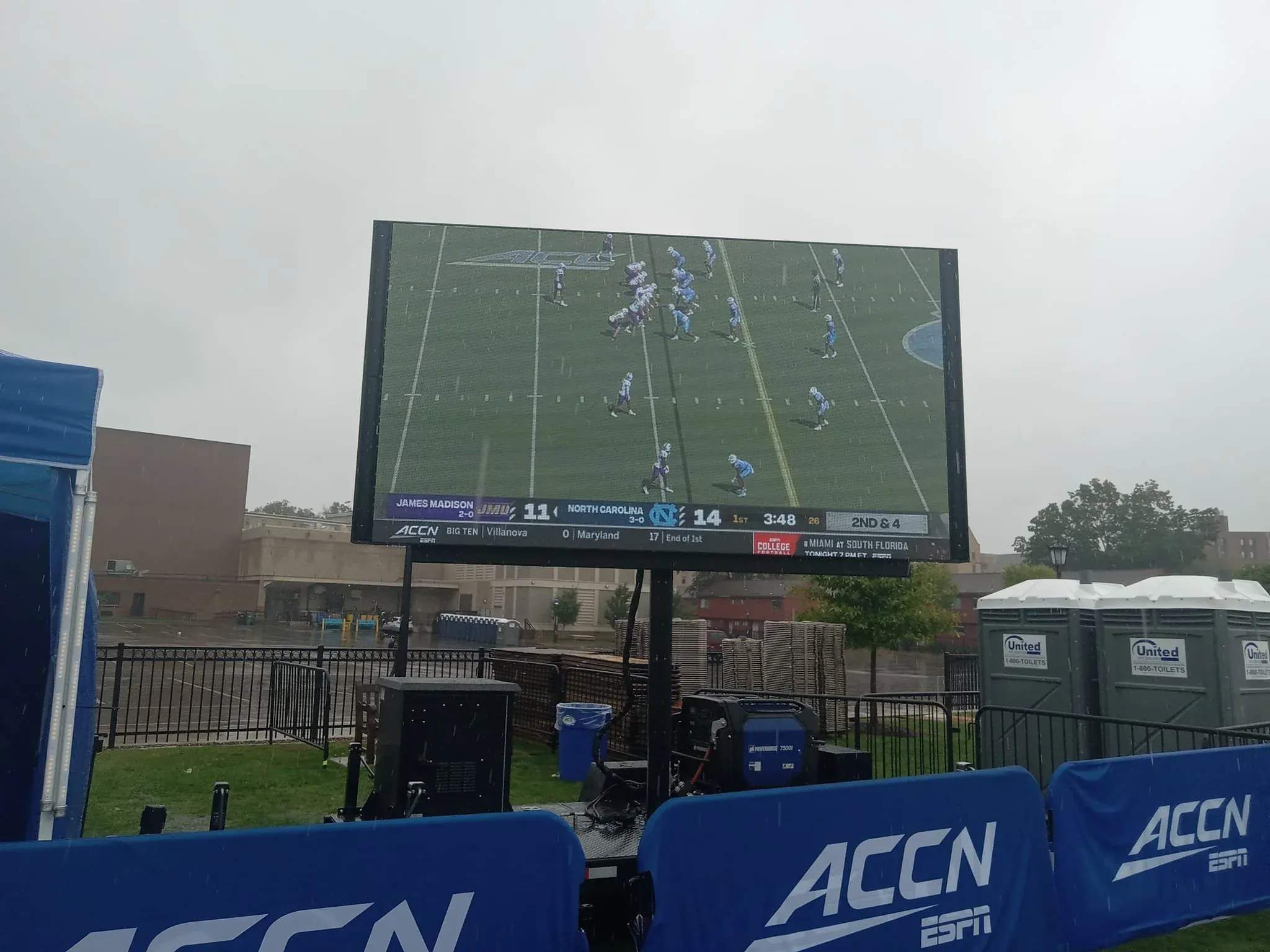 Full stage production with LED displays and concert lighting beams